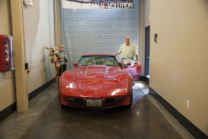 Pictured: Sue Alexander and brother-in-law Doug Alexander donate Kenny Alexander's former Corvette.